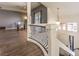 A curved staircase with wood floors and ornate railings overlooks the living area at 6843 Philharmonic Ave, Las Vegas, NV 89139