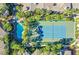 Aerial view of the sparkling community pool and tennis courts surrounded by lush landscaping and meticulously manicured grounds at 7151 S Durango Dr # 312, Las Vegas, NV 89113