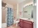 Well-lit bathroom with tub-shower combination, cherry vanity, and modern fixtures at 7151 S Durango Dr # 312, Las Vegas, NV 89113
