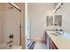 Bright bathroom with a glass-enclosed shower, large mirror, and wooden vanity with a sink at 7151 S Durango Dr # 312, Las Vegas, NV 89113