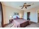 Bedroom featuring neutral walls, brown carpeting, a ceiling fan, and a window with brown curtains at 7151 S Durango Dr # 312, Las Vegas, NV 89113