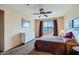 The bedroom features neutral walls, a window with brown curtains providing a scenic view, and brown carpeting at 7151 S Durango Dr # 312, Las Vegas, NV 89113