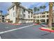 Attractive condo building with private garages, surrounded by palm trees and well-maintained landscaping at 7151 S Durango Dr # 312, Las Vegas, NV 89113
