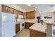 Kitchen with ample counter space, white appliances, and light wood cabinets at 7151 S Durango Dr # 312, Las Vegas, NV 89113