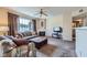 Cozy living room with fireplace, ceiling fan, and plush seating at 7151 S Durango Dr # 312, Las Vegas, NV 89113