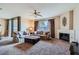 Well lit Living room features plush seating, fireplace, and a ceiling fan at 7151 S Durango Dr # 312, Las Vegas, NV 89113