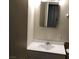 This bathroom features a sink with a mirror, toilet, and clean, neutral decor at 725 Miller Ave, North Las Vegas, NV 89030