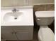 A functional bathroom showcasing a white vanity, toilet, and tiled accents at 725 Miller Ave, North Las Vegas, NV 89030