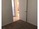 Cozy bedroom featuring neutral walls, carpet flooring, and an attached bathroom for added convenience at 725 Miller Ave, North Las Vegas, NV 89030