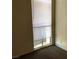Bedroom with neutral walls, window with blinds, and an electrical outlet at 725 Miller Ave, North Las Vegas, NV 89030