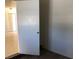 Hallway featuring an open door, neutral walls, and tile flooring at 725 Miller Ave, North Las Vegas, NV 89030