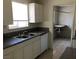 Kitchen features white cabinets, double sink, and a granite-look countertop at 725 Miller Ave, North Las Vegas, NV 89030