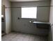 Laundry room featuring white walls, tile floors, and a foldable table at 725 Miller Ave, North Las Vegas, NV 89030