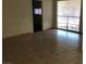 Bright living room featuring tile flooring, large windows, and neutral wall paint at 725 Miller Ave, North Las Vegas, NV 89030