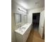 Bathroom with double sinks, white cabinets, and modern lighting at 7664 Angel Crest Cir, Las Vegas, NV 89117