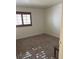 Bedroom featuring neutral carpet, baseboards, and window at 7664 Angel Crest Cir, Las Vegas, NV 89117