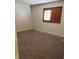 Bedroom featuring neutral carpet, baseboards, and window at 7664 Angel Crest Cir, Las Vegas, NV 89117