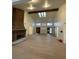 Spacious living room with a brick fireplace, high ceilings, wood beams, and large windows at 7664 Angel Crest Cir, Las Vegas, NV 89117