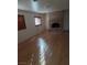 Living room with hardwood floors, shutters, and brick fireplace at 7664 Angel Crest Cir, Las Vegas, NV 89117