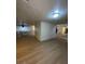 Open floor plan with hardwood floors connecting living spaces and kitchen area at 7664 Angel Crest Cir, Las Vegas, NV 89117