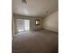 Comfortable carpeted living room featuring large windows for natural light and outdoor views at 7664 Angel Crest Cir, Las Vegas, NV 89117