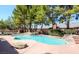 A large, inviting pool is surrounded by mature trees and an in-ground hot tub at 7664 Angel Crest Cir, Las Vegas, NV 89117