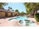 A private backyard features a sparkling pool, spa, and ample lounging space at 7664 Angel Crest Cir, Las Vegas, NV 89117
