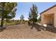 Landscaped backyard with drought tolerant xeriscaping with mature trees and neighborhood views at 7824 Pine Warbler Way, North Las Vegas, NV 89084