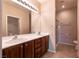 Bathroom with double sink vanity, shower, and tile flooring at 7824 Pine Warbler Way, North Las Vegas, NV 89084