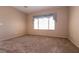 Neutral bedroom with plush carpet, natural light, and a decorative window treatment at 7824 Pine Warbler Way, North Las Vegas, NV 89084