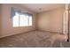 Spacious bedroom featuring plush carpet, natural light, and neutral walls at 7824 Pine Warbler Way, North Las Vegas, NV 89084
