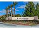 Sun City Aliante community sign surrounded by landscaping and palm trees at 7824 Pine Warbler Way, North Las Vegas, NV 89084