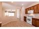 Open kitchen features white appliances and dark wood cabinets at 7824 Pine Warbler Way, North Las Vegas, NV 89084