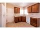 Bright kitchen with wood cabinets, white dishwasher, and tile flooring at 7824 Pine Warbler Way, North Las Vegas, NV 89084
