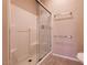 Shower featuring glass doors, white tile, and updated fixtures at 7824 Pine Warbler Way, North Las Vegas, NV 89084