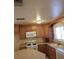 A well-lit kitchen featuring wood cabinets and modern appliances at 7990 Firethorn, Las Vegas, NV 89123