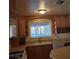A bright kitchen showcases wood cabinetry and a large window that brings in lots of light at 7990 Firethorn, Las Vegas, NV 89123