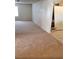Living room features neutral carpet, white walls, and a glimpse of the kitchen at 7990 Firethorn, Las Vegas, NV 89123