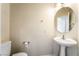 Cozy powder room with pedestal sink and classic fixtures at 824 Bussora Rose Dr, Henderson, NV 89015