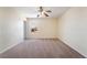 Cozy bedroom with neutral carpet, ceiling fan, and bright natural light from the window at 824 Bussora Rose Dr, Henderson, NV 89015