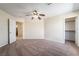 Bedroom featuring neutral carpeting, ceiling fan, and multiple doorways leading to other rooms at 824 Bussora Rose Dr, Henderson, NV 89015