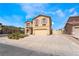 Inviting two-story home showcasing neutral color scheme, neat landscaping, and ample driveway parking at 824 Bussora Rose Dr, Henderson, NV 89015