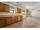 Well-lit kitchen featuring wooden cabinets, stainless steel dishwasher, and outdoor view at 824 Bussora Rose Dr, Henderson, NV 89015