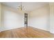 Bright room featuring wood floors, chandelier, and adjacent doorway at 824 Bussora Rose Dr, Henderson, NV 89015