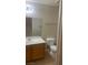 Bathroom vanity featuring a large mirror, single sink, and toilet with a neutral color scheme at 8664 Traveling Breeze Ave # 102, Las Vegas, NV 89178