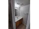 Compact bathroom features a single sink vanity, mirror, and tile flooring at 8664 Traveling Breeze Ave # 102, Las Vegas, NV 89178
