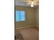 Bedroom featuring neutral walls, carpeted flooring, and a window for natural light at 8664 Traveling Breeze Ave # 102, Las Vegas, NV 89178