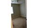 An empty bedroom with neutral carpet and a ceiling fan, ready for new decor and personalization at 8664 Traveling Breeze Ave # 102, Las Vegas, NV 89178