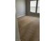 Bedroom with two windows, allowing natural light, and neutral carpet at 8664 Traveling Breeze Ave # 102, Las Vegas, NV 89178