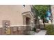 Inviting townhouse exterior with a small porch and well-maintained landscaping at 8664 Traveling Breeze Ave # 102, Las Vegas, NV 89178